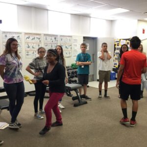 A group of teens doing a team building activity in a classroom