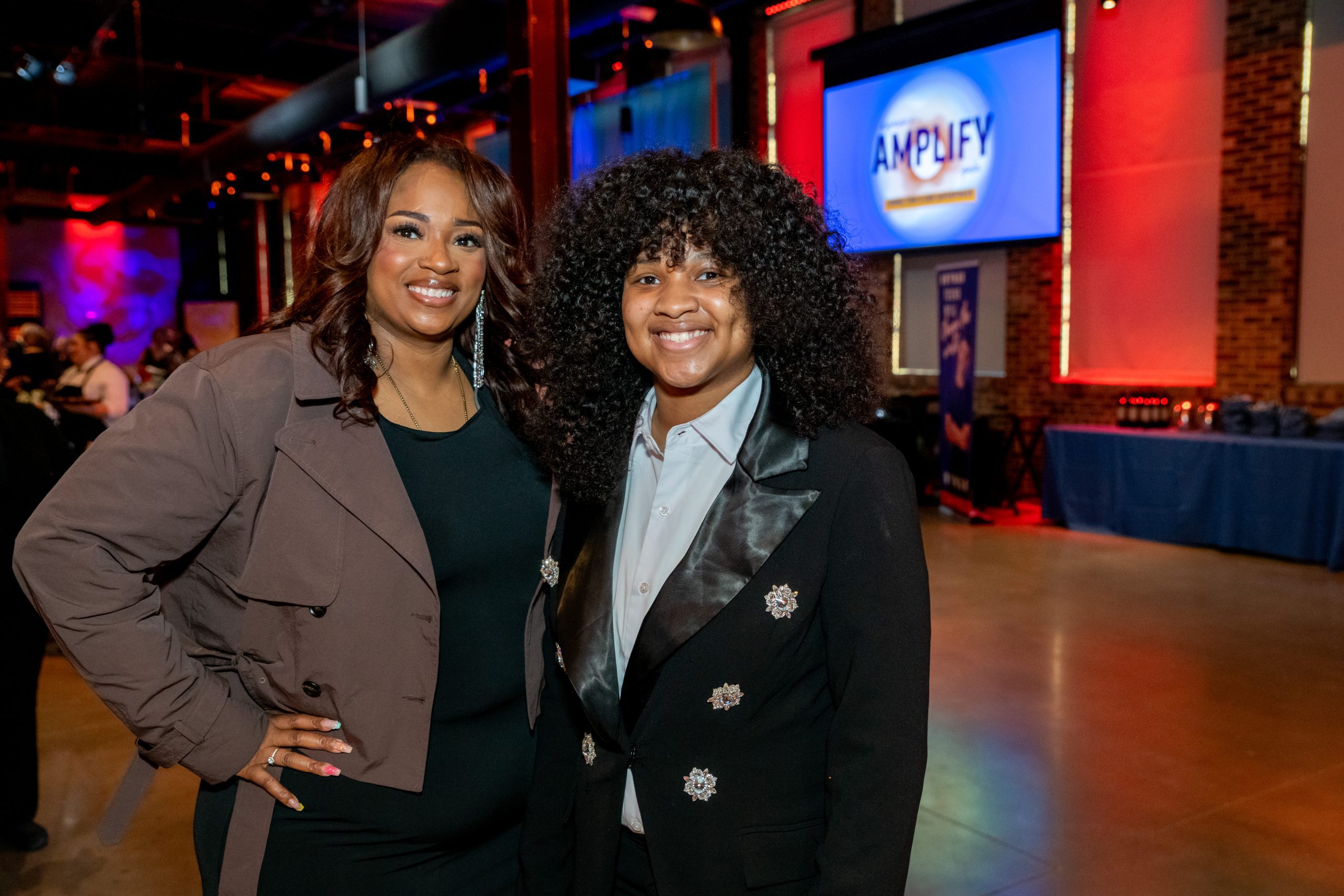 photo of a teen and her mom posing for the camera at nice event