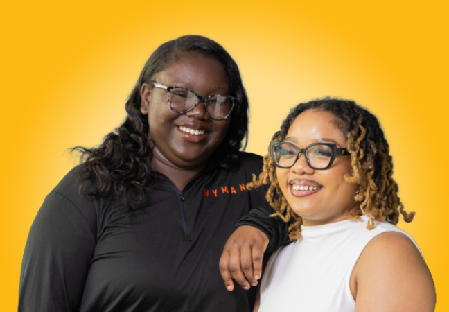two young women smile at the camera