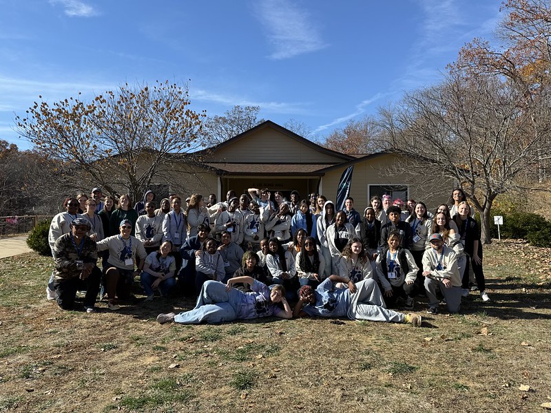 group gathered in front of camp building